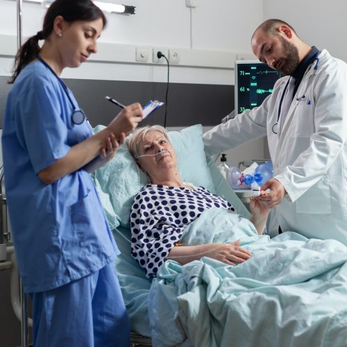 Doctor checking senior patient in hospital intensive care